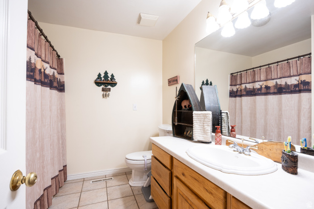 1981 South Main Street Lewiston, UT 84320 - Photo 13 of 47 Full bath featuring a shower with shower curtain, vanity, and light tile patterned flooring