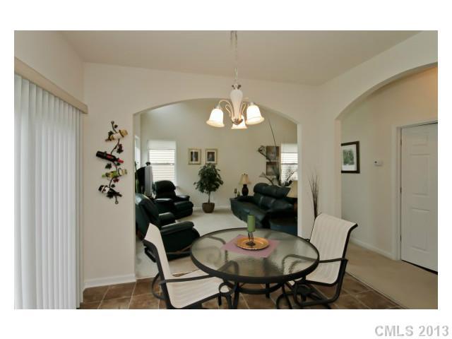 3342 Streamside Drive Davidson, NC 28036 - Photo 5 of 16 a dining room with furniture and a chandelier