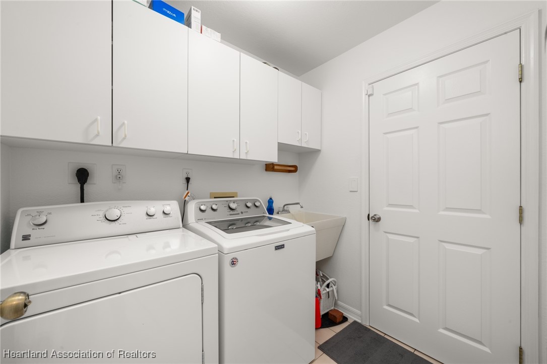 4500 Del Rio Court Sebring, FL 33875 - Photo 23 of 32 Laundry room with cabinets, laundry tub, washer and dryer included