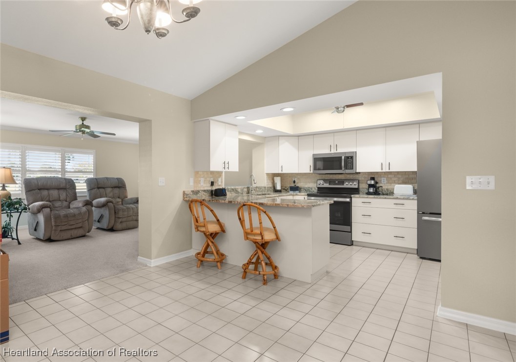4500 Del Rio Court Sebring, FL 33875 - Photo 8 of 32 Breakfast bar into family room and dining room