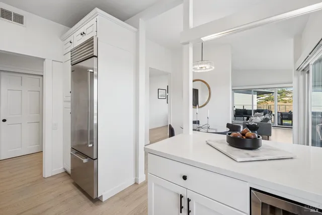 a kitchen with a sink and a mirror