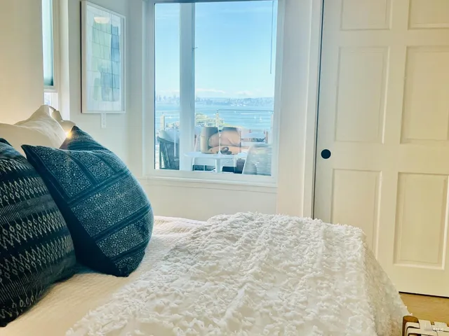 a living room with a large bed and a large window