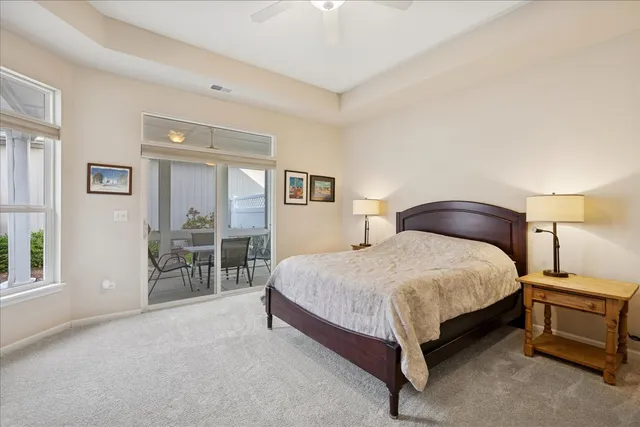 a spacious bedroom with a bed and a cabinets