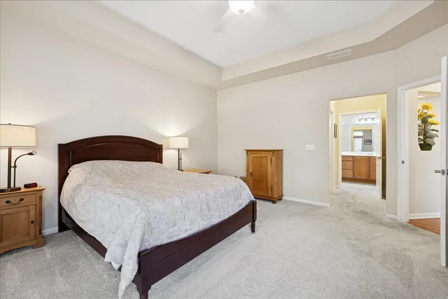 a bedroom with a bed and flowerpot