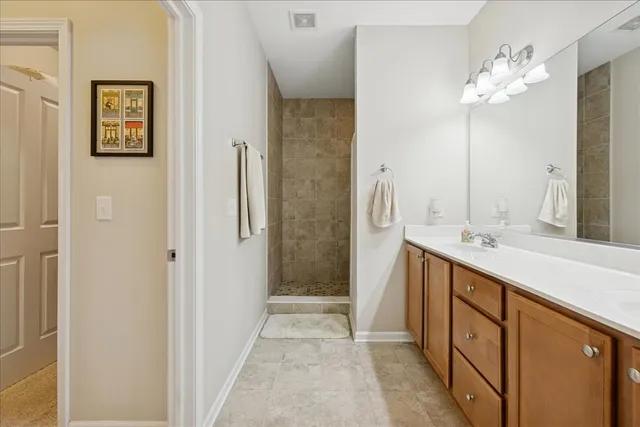 a spacious bathroom with a shower sink and mirror