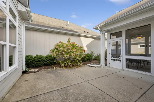a view of a house with potted plants