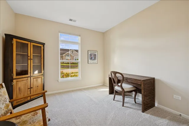 a view of workspace with furniture and windows