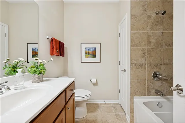 a bath room with a toilet a sink and a bath tub