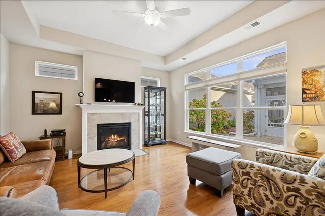 a living room with furniture a flat screen tv and a fireplace