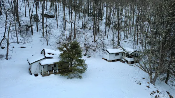 an aerial view of a house with yard patio and outdoor seating