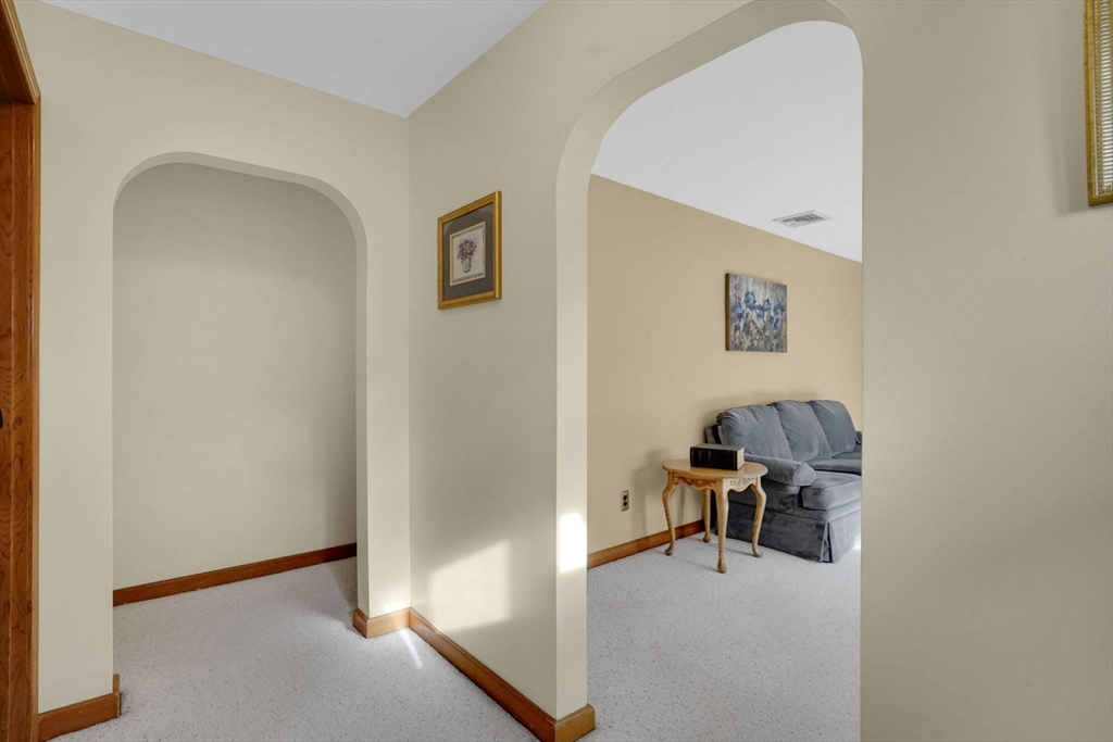 76 Roy Street Chicopee, MA 01013 - Photo 12 of 30 a view of a livingroom with a chair and potted plant