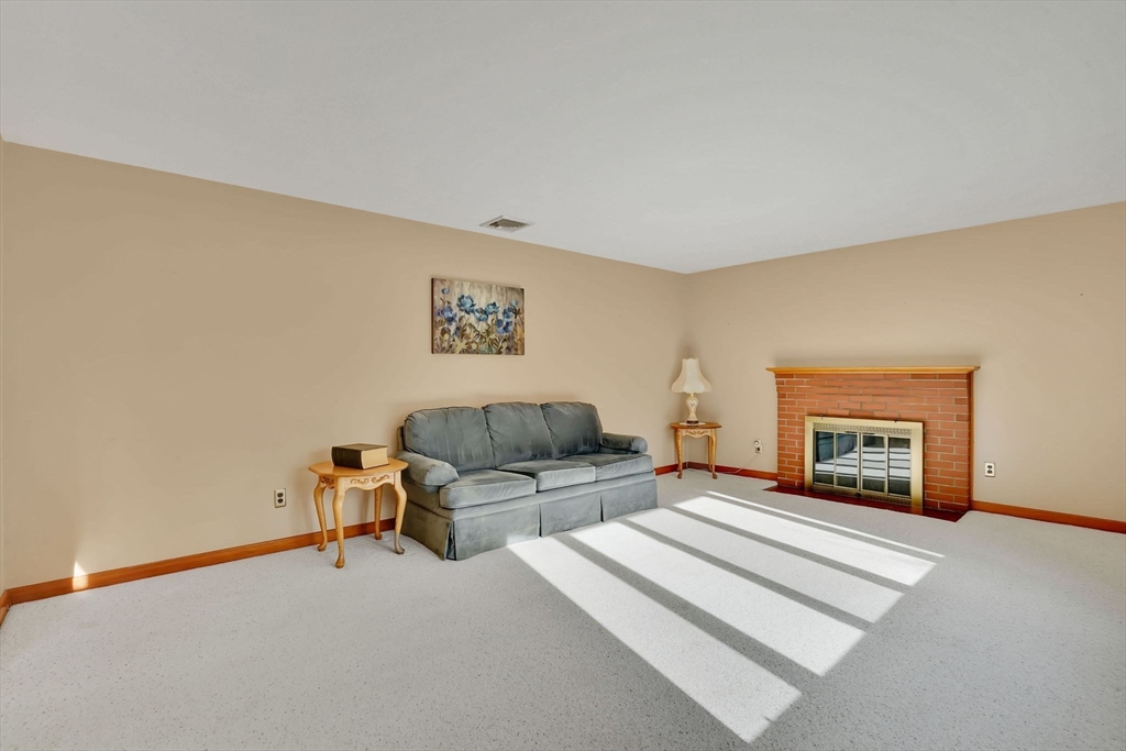 76 Roy Street Chicopee, MA 01013 - Photo 14 of 30 a bedroom with a bed and a fireplace