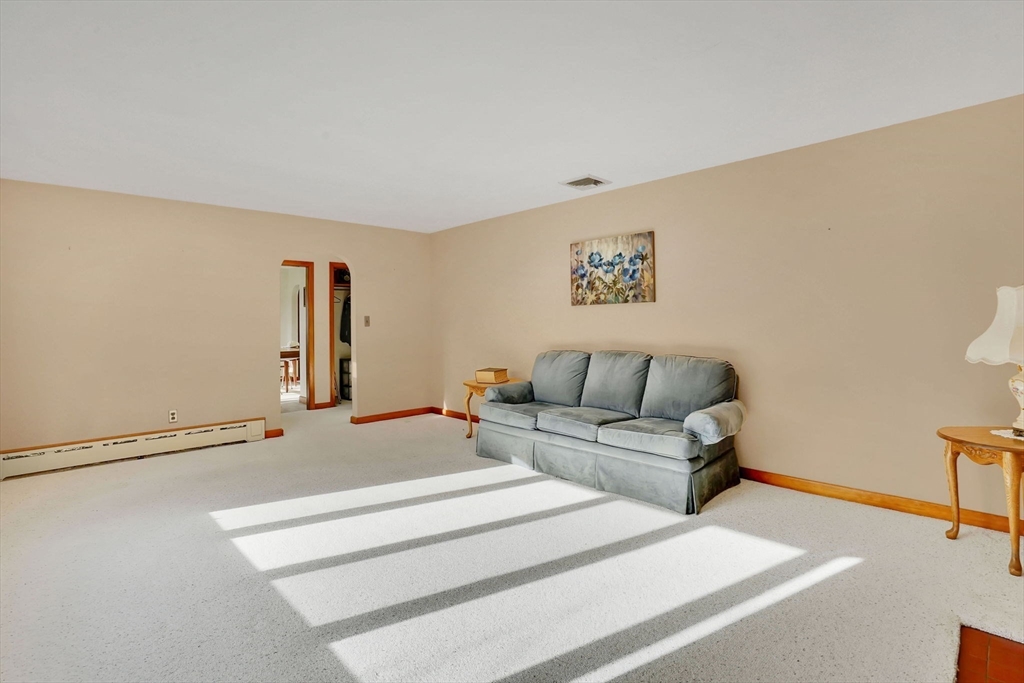 76 Roy Street Chicopee, MA 01013 - Photo 16 of 30 a living room with furniture and a potted plant on a dresser