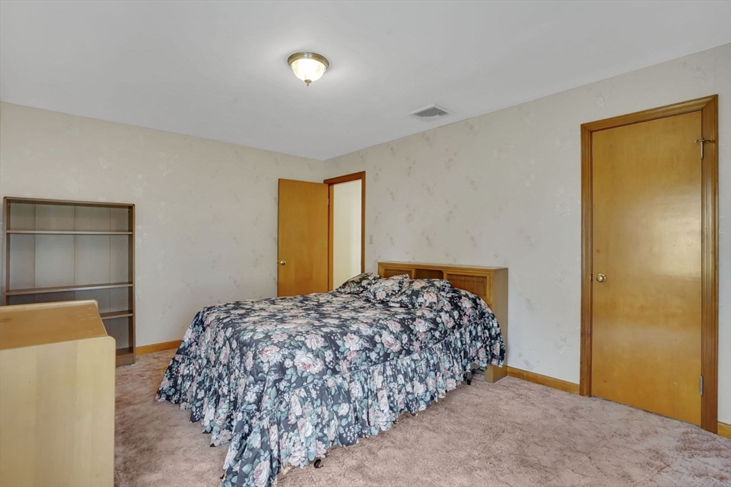 76 Roy Street Chicopee, MA 01013 - Photo 19 of 30 a bedroom with a bed and a window