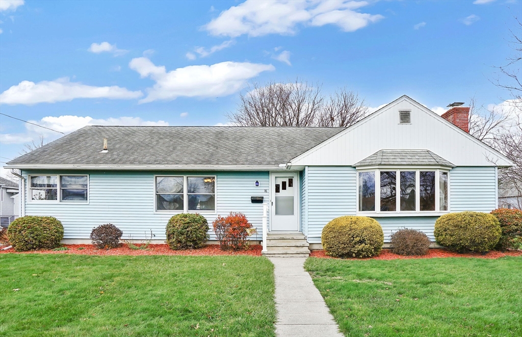 76 Roy Street Chicopee, MA 01013 - Photo 2 of 30 a front view of a house with a yard and garage