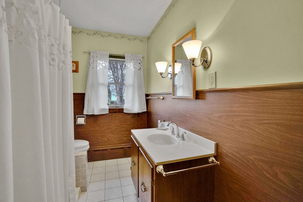 76 Roy Street Chicopee, MA 01013 - Photo 22 of 30 a bathroom with a sink and a mirror
