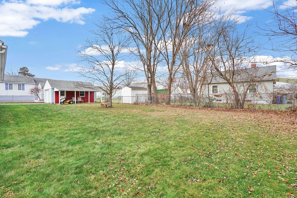 76 Roy Street Chicopee, MA 01013 - Photo 29 of 30 a view of a yard with a house in the background