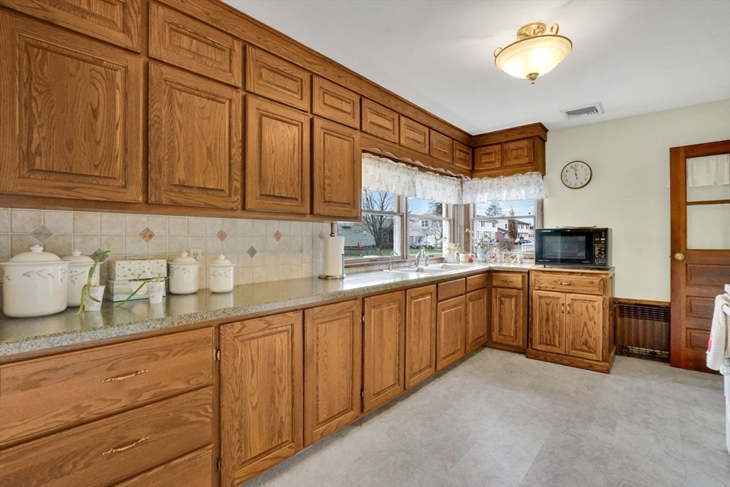 76 Roy Street Chicopee, MA 01013 - Photo 4 of 30 a kitchen with cabinets and window