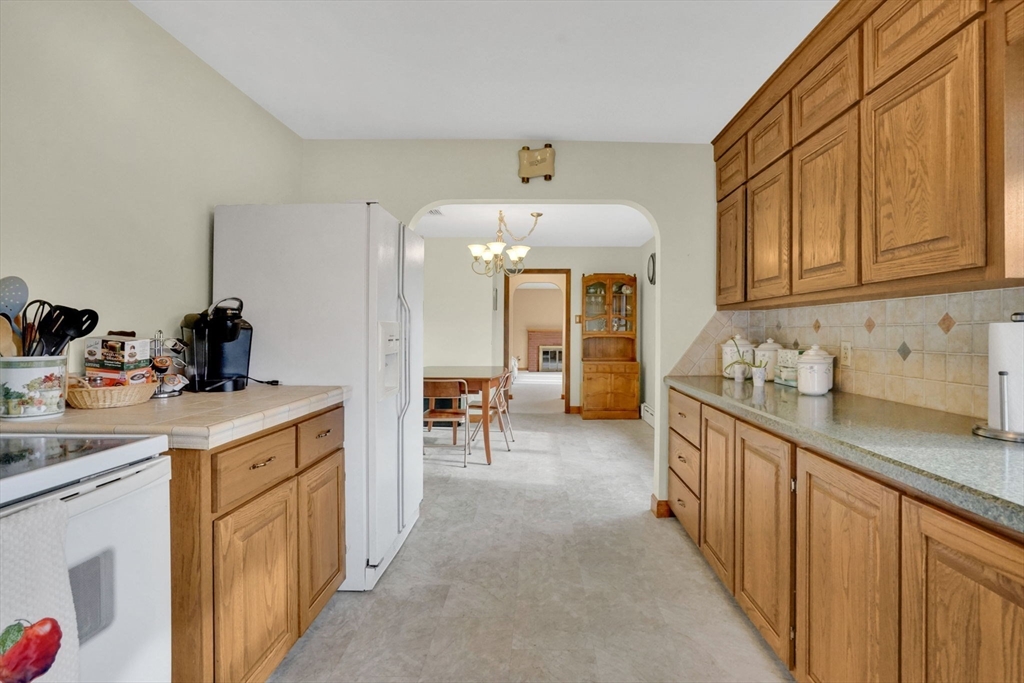 76 Roy Street Chicopee, MA 01013 - Photo 7 of 30 a kitchen that has a lot of cabinets in it
