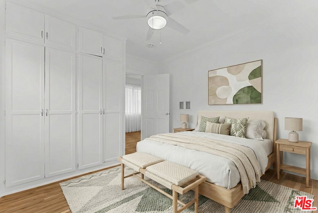 2948 Exposition Boulevard, Unit 5 Santa Monica, CA 90404 - Photo 6 of 13 a bedroom with a bed and a painting on the wall