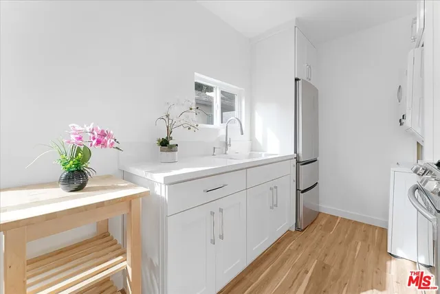 a kitchen with white cabinets and a sink