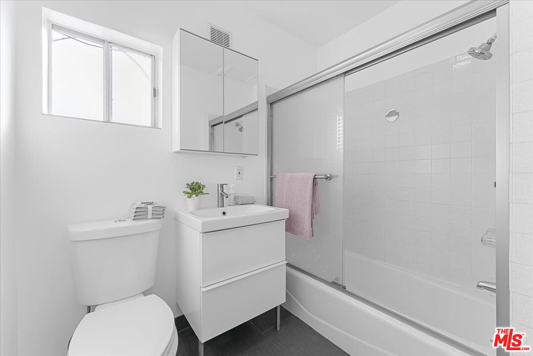 2948 Exposition Boulevard, Unit 5 Santa Monica, CA 90404 - Photo 10 of 13 a bathroom with a sink a toilet and shower