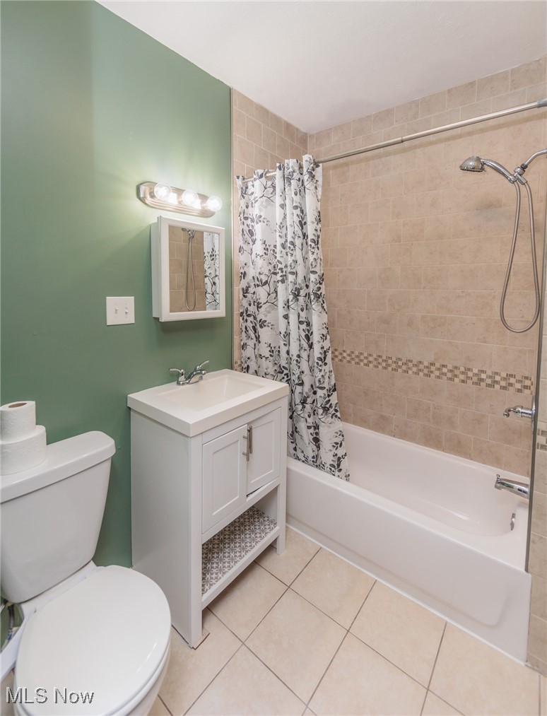 3181 Warren Road Cleveland, OH 44111 - Photo 11 of 28 Full bathroom featuring shower / bath combo, tile patterned flooring, vanity, and toilet