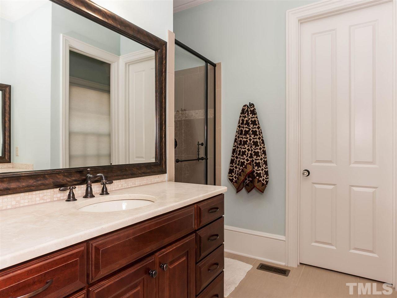 416 Wayne Drive Raleigh, NC 27608 - Photo 14 of 25 a bathroom with a sink and a mirror