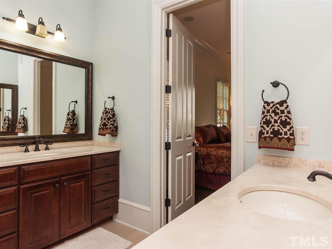 416 Wayne Drive Raleigh, NC 27608 - Photo 15 of 25 a en suite bathroom with a granite countertop sink and a mirror