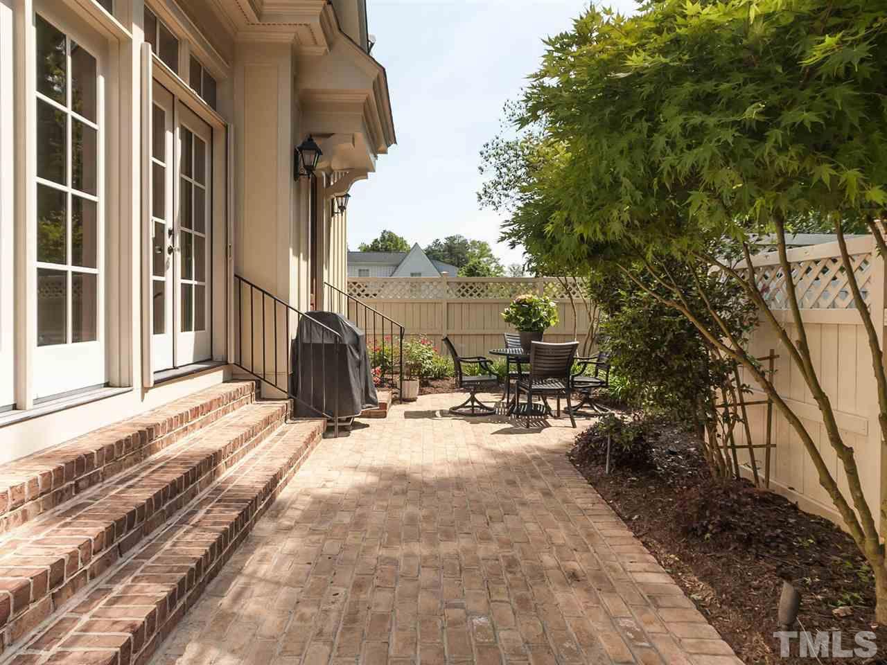 416 Wayne Drive Raleigh, NC 27608 - Photo 23 of 25 a view of a backyard of a house with table and chairs and floor to ceiling window