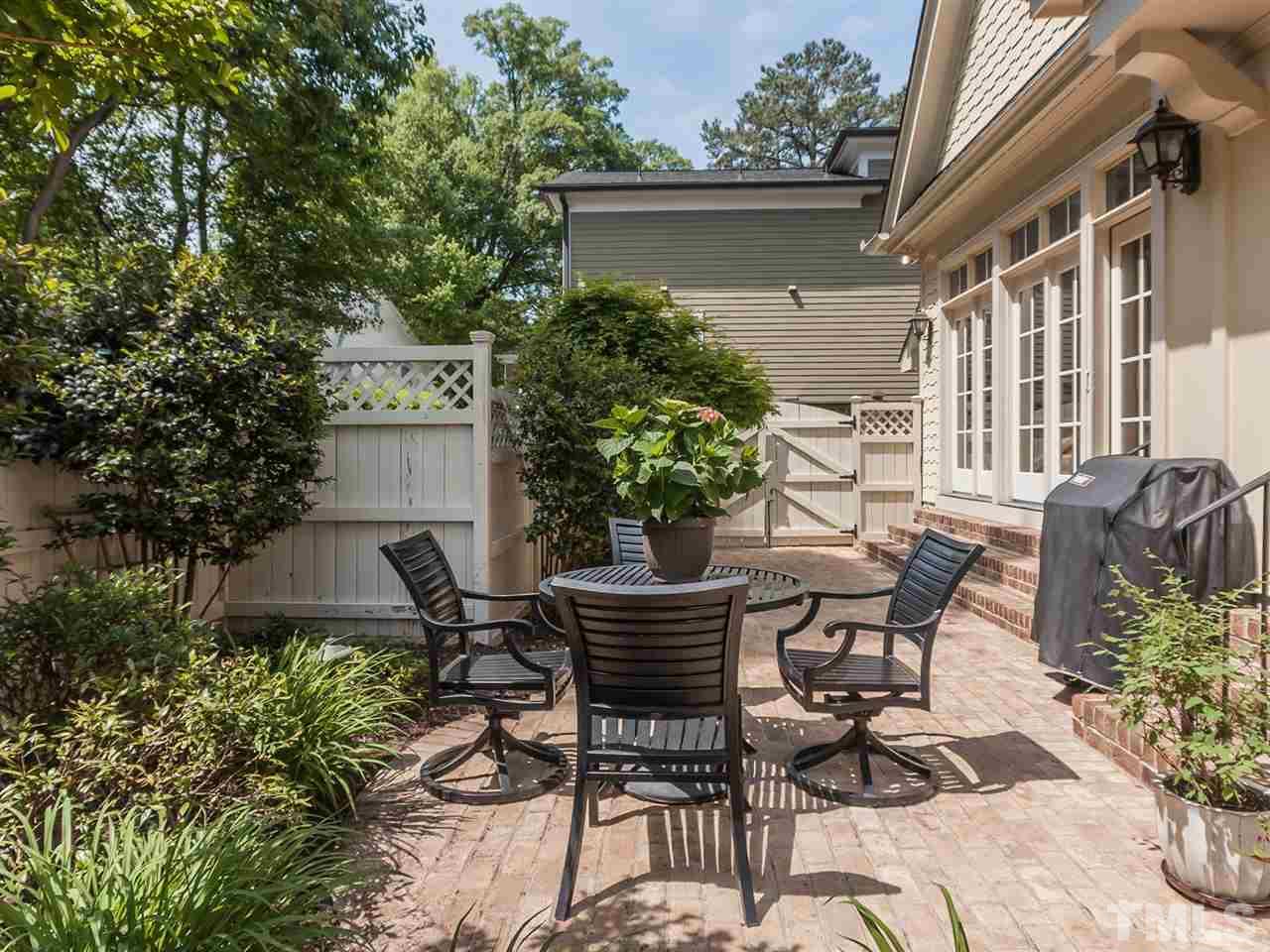416 Wayne Drive Raleigh, NC 27608 - Photo 25 of 25 a view of patio with table and chairs and potted plants
