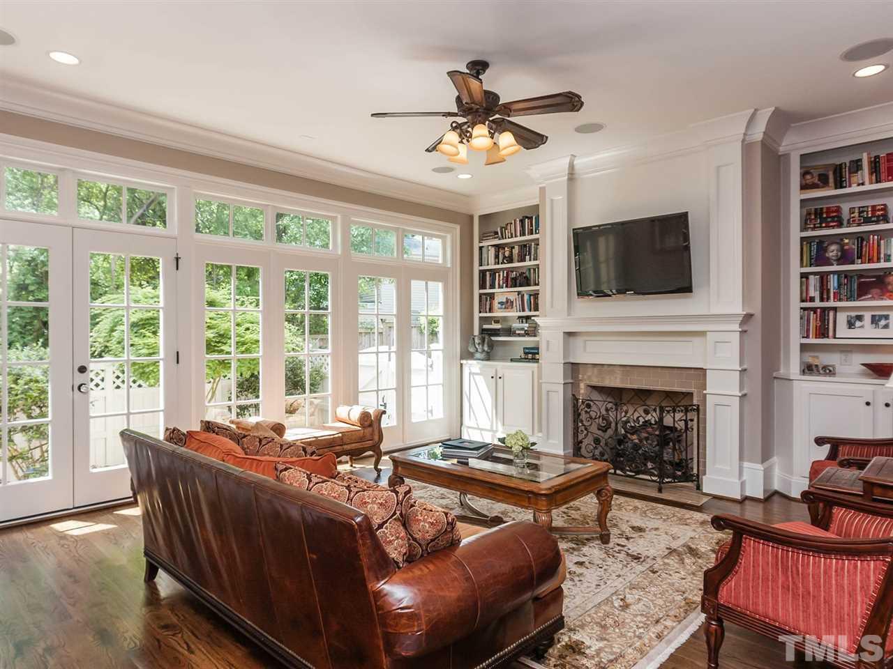416 Wayne Drive Raleigh, NC 27608 - Photo 5 of 25 a living room with furniture a fireplace and a flat screen tv