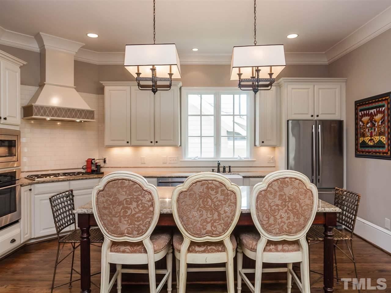 416 Wayne Drive Raleigh, NC 27608 - Photo 8 of 25 a kitchen with granite countertop a table chairs stove a refrigerator and cabinets