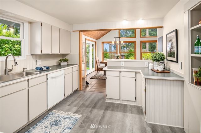 a kitchen with a stove a sink and a refrigerator