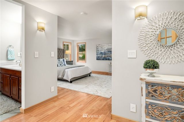 a view of a bedroom with tub and windows