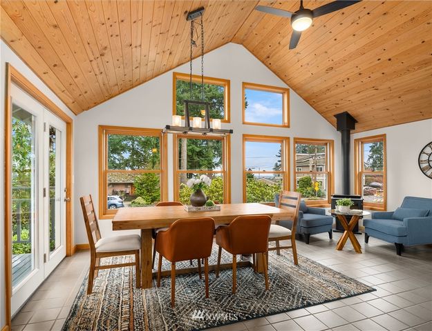 a view of a dining room with furniture large windows and wooden floor