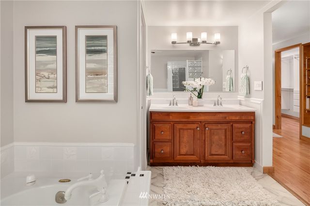 a bathroom with a tub sink and shower