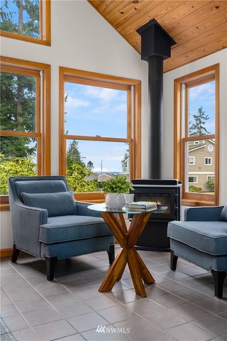 a living room with furniture and floor to ceiling windows