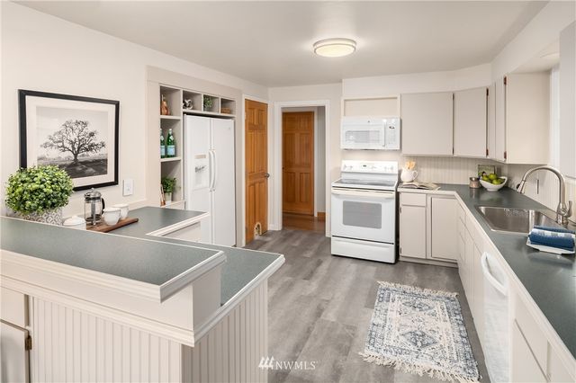 a kitchen with stainless steel appliances a sink a stove and a refrigerator