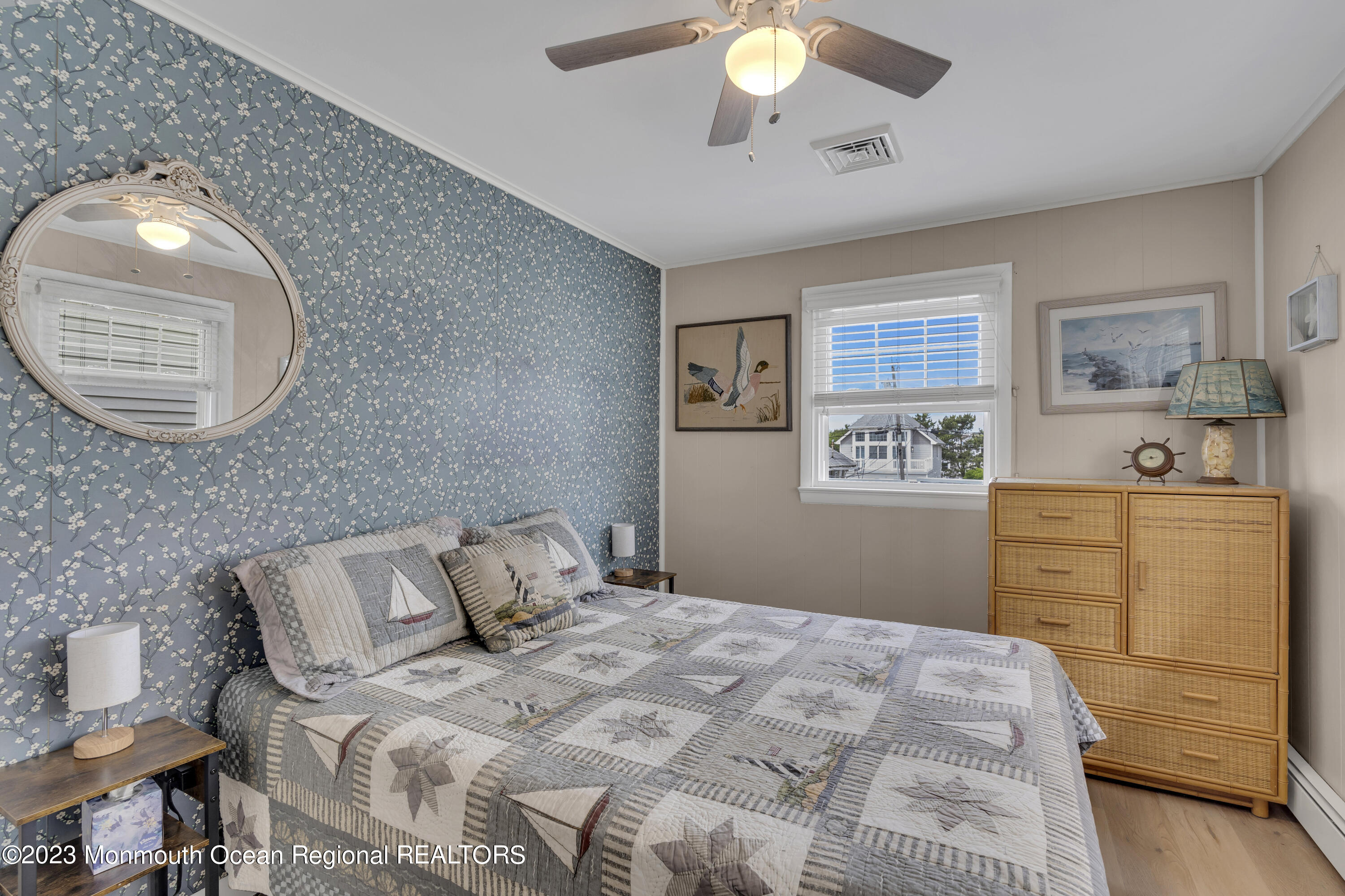 61 Beach Front Manasquan, NJ 08736 - Photo 9 of 20 a bedroom with a bed and cabinets