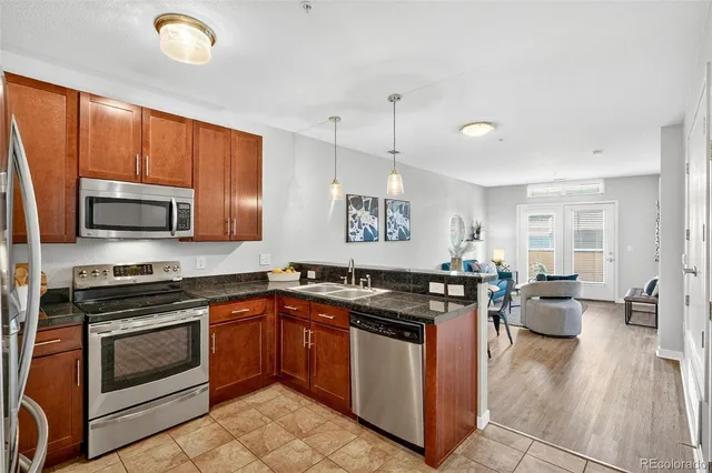a kitchen with granite countertop a stove top oven sink and cabinets