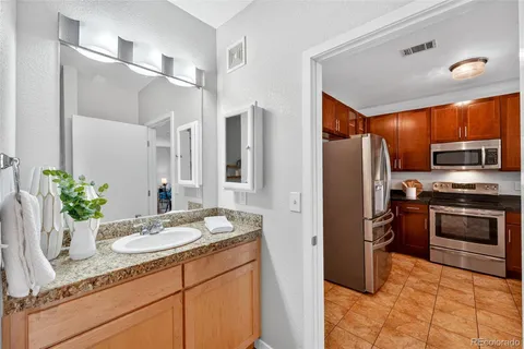 a kitchen with stainless steel appliances granite countertop a refrigerator and a sink