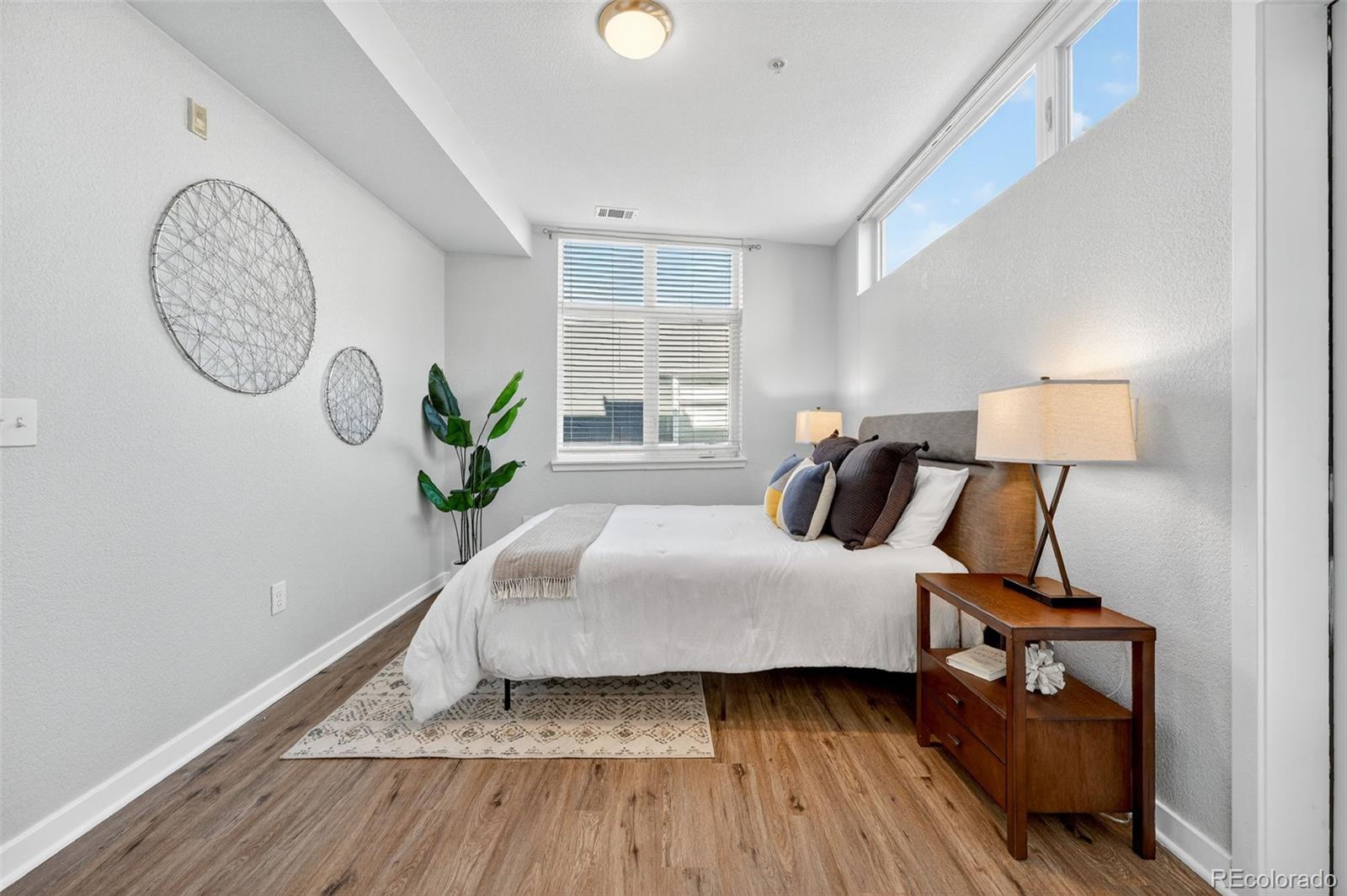 3101 Blake Street, Unit 209 Denver, CO 80205 - Photo 19 of 33 a bedroom with bed and a window
