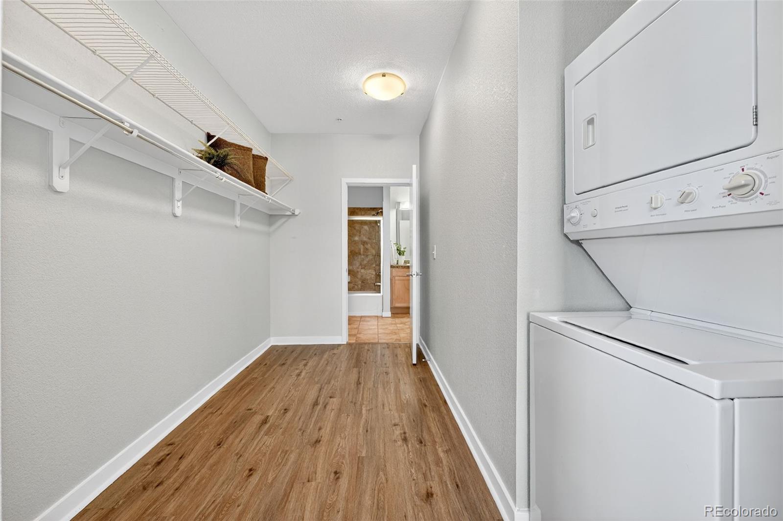 3101 Blake Street, Unit 209 Denver, CO 80205 - Photo 23 of 33 a view of a hallway with wooden floor