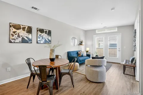 a dining room with furniture and wooden floor