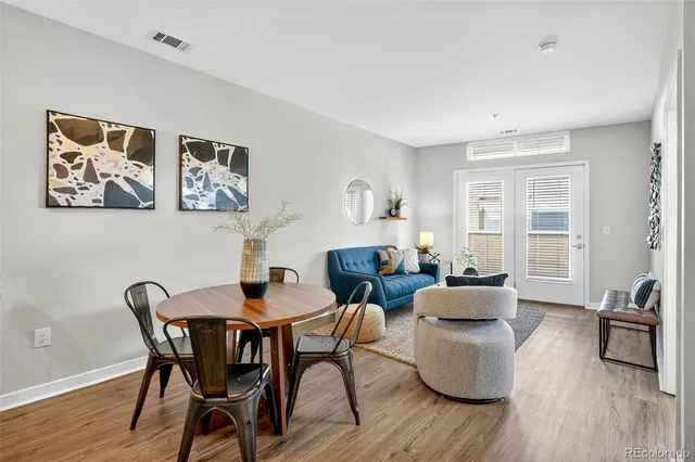 a dining room with furniture and wooden floor