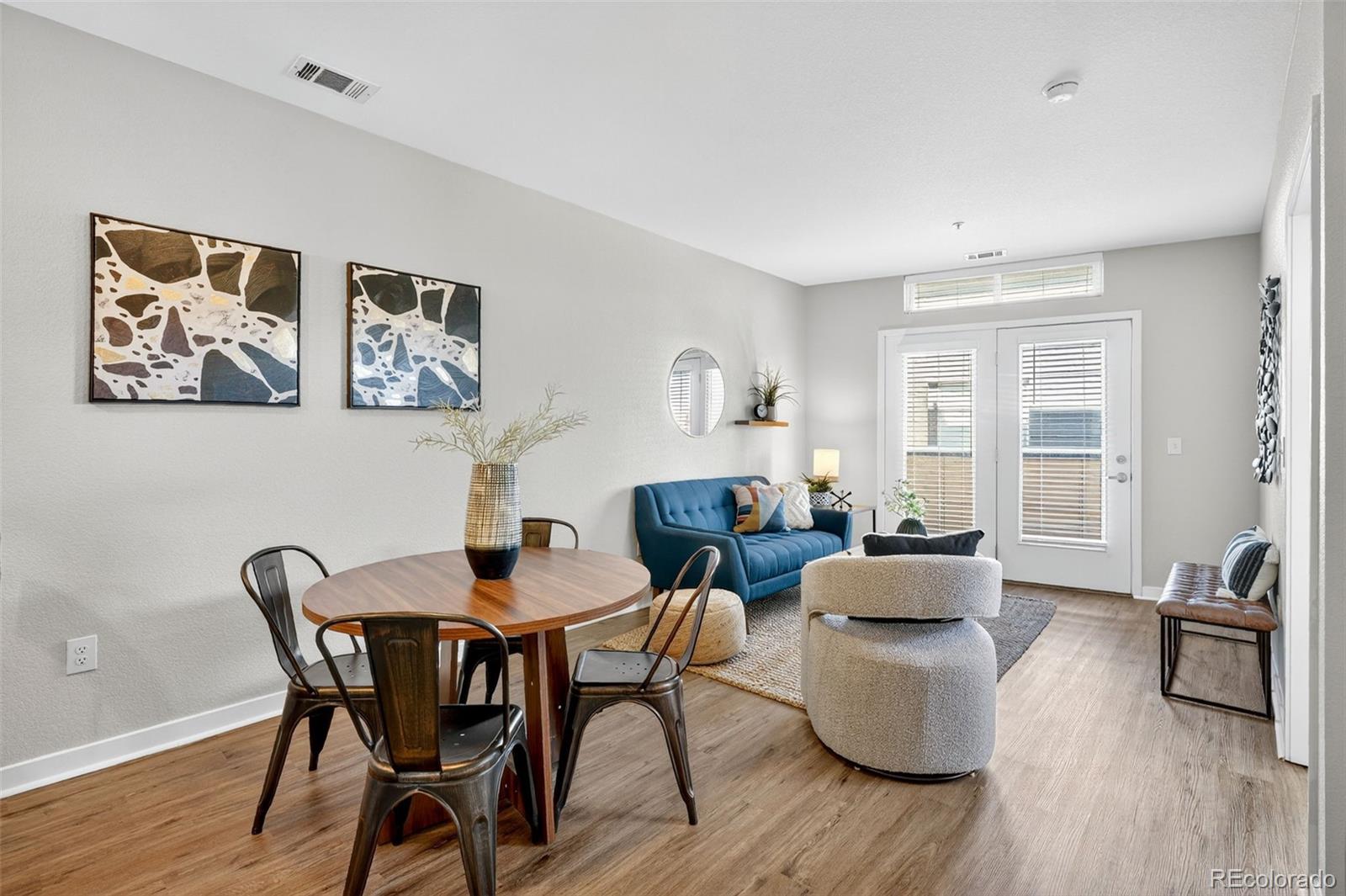 3101 Blake Street, Unit 209 Denver, CO 80205 - Photo 9 of 33 a dining room with furniture and wooden floor