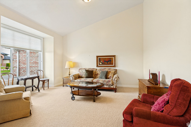 298 North Canyon Road Bountiful, UT 84010 - Photo 8 of 57 Living area featuring a vaulted ceiling and a broad bay window with a roller shade