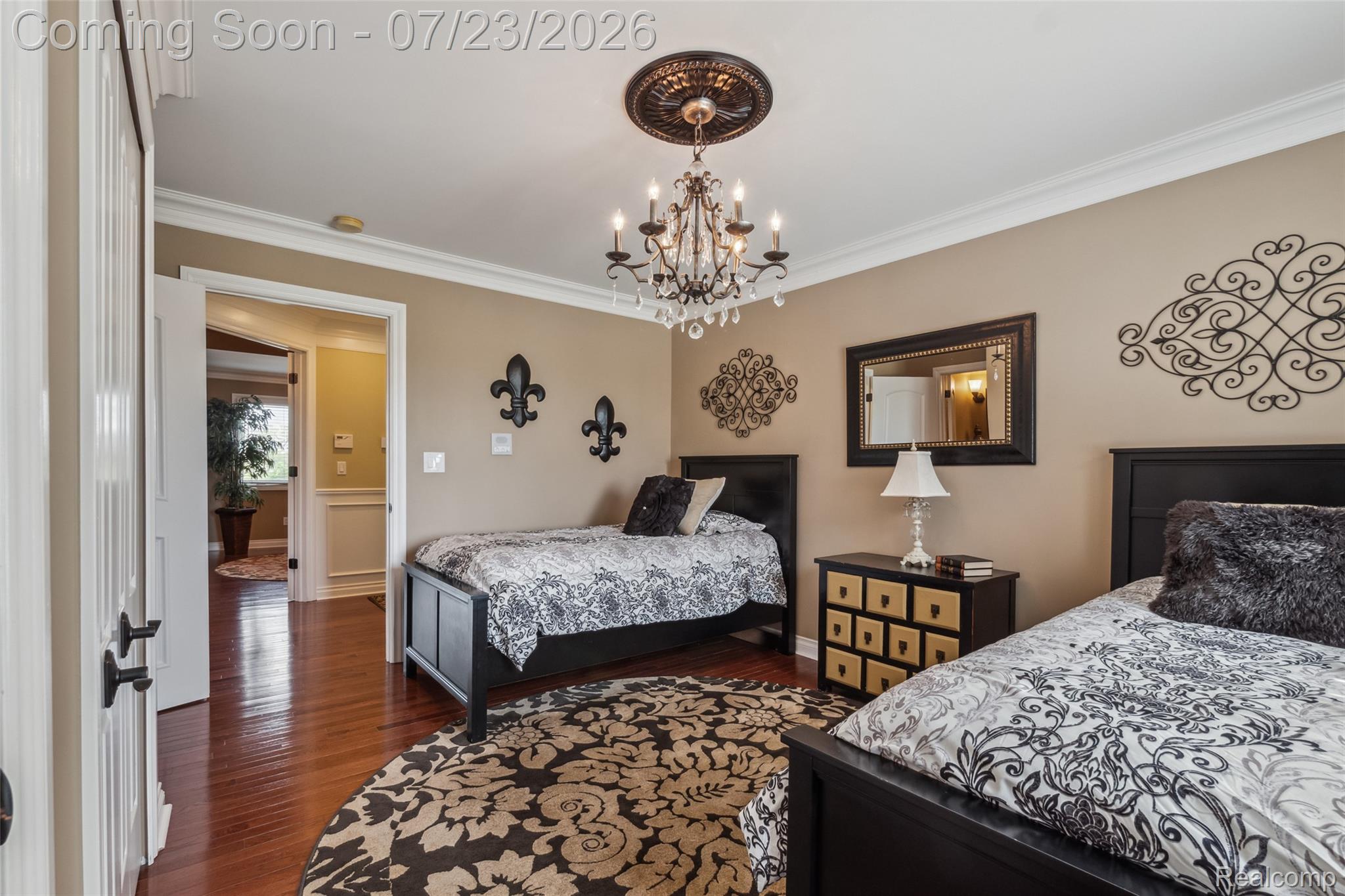 5460 Cochrane Road Almont, MI 48003 - Photo 26 of 48 Hardwood flooring throughout this room features crown molding and a prominent chandelier