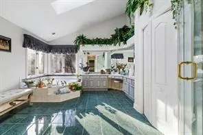 a bedroom with a large bed and a chandelier